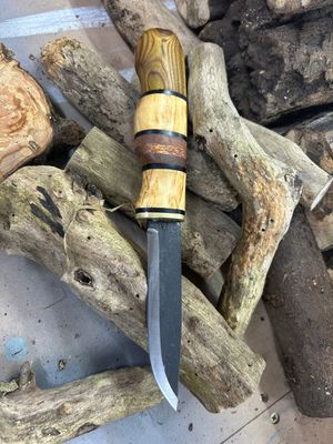 Wooden-handled knife on logs