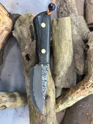 Damascus steel knife on wood