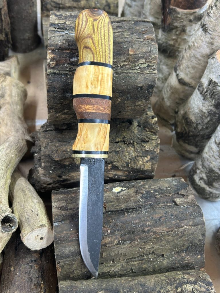 Wooden-handled knife on logs